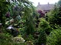The house and pond, viewed from the bottom of the  rhododendron dell