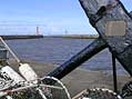 Wooden stock anchor on the harbour quayside