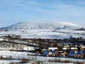 A snow covered Brown Wardle hill from Cowm Reservoir